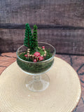 Flickering candle in mossy woodland scene
