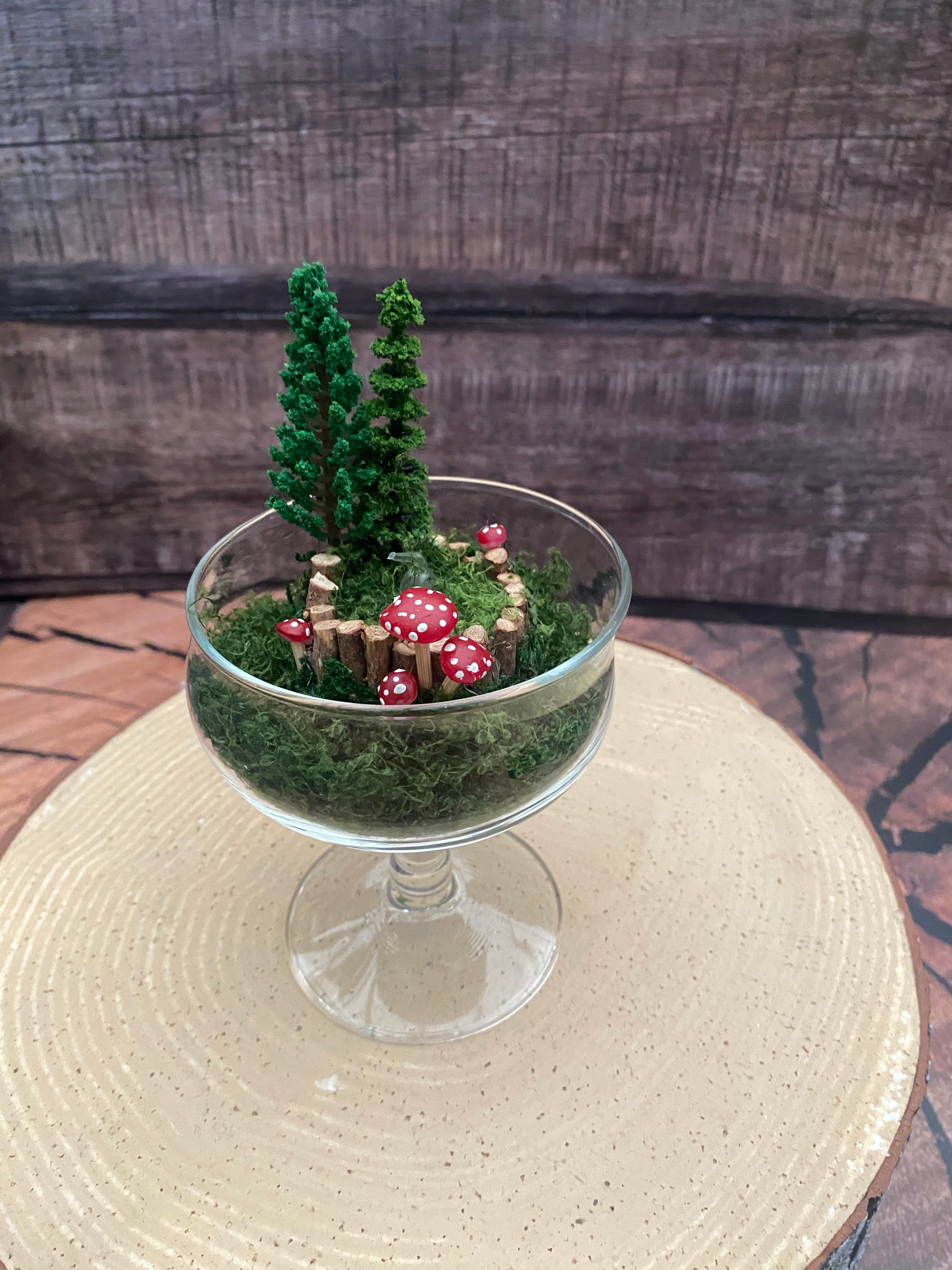 Flickering candle in mossy woodland scene