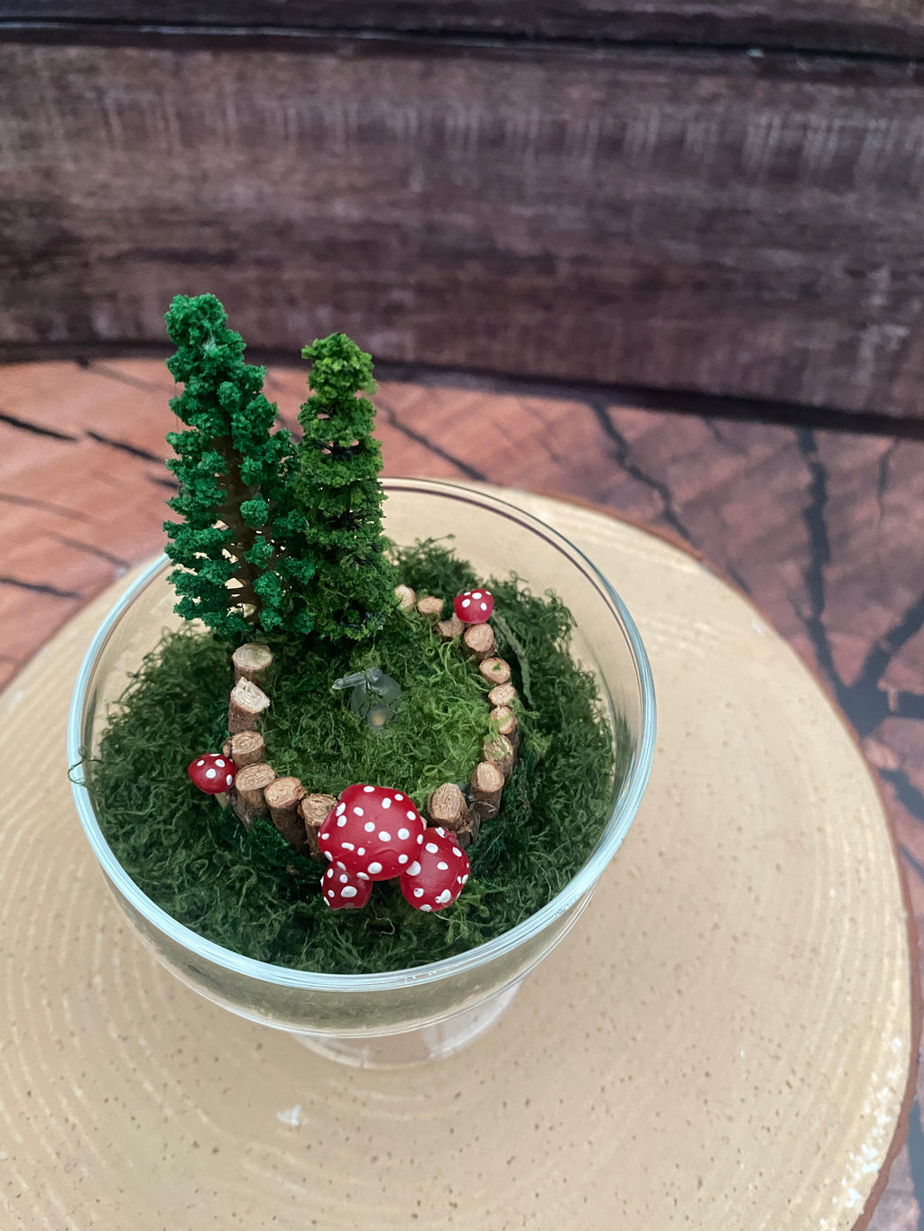 Flickering candle in mossy woodland scene