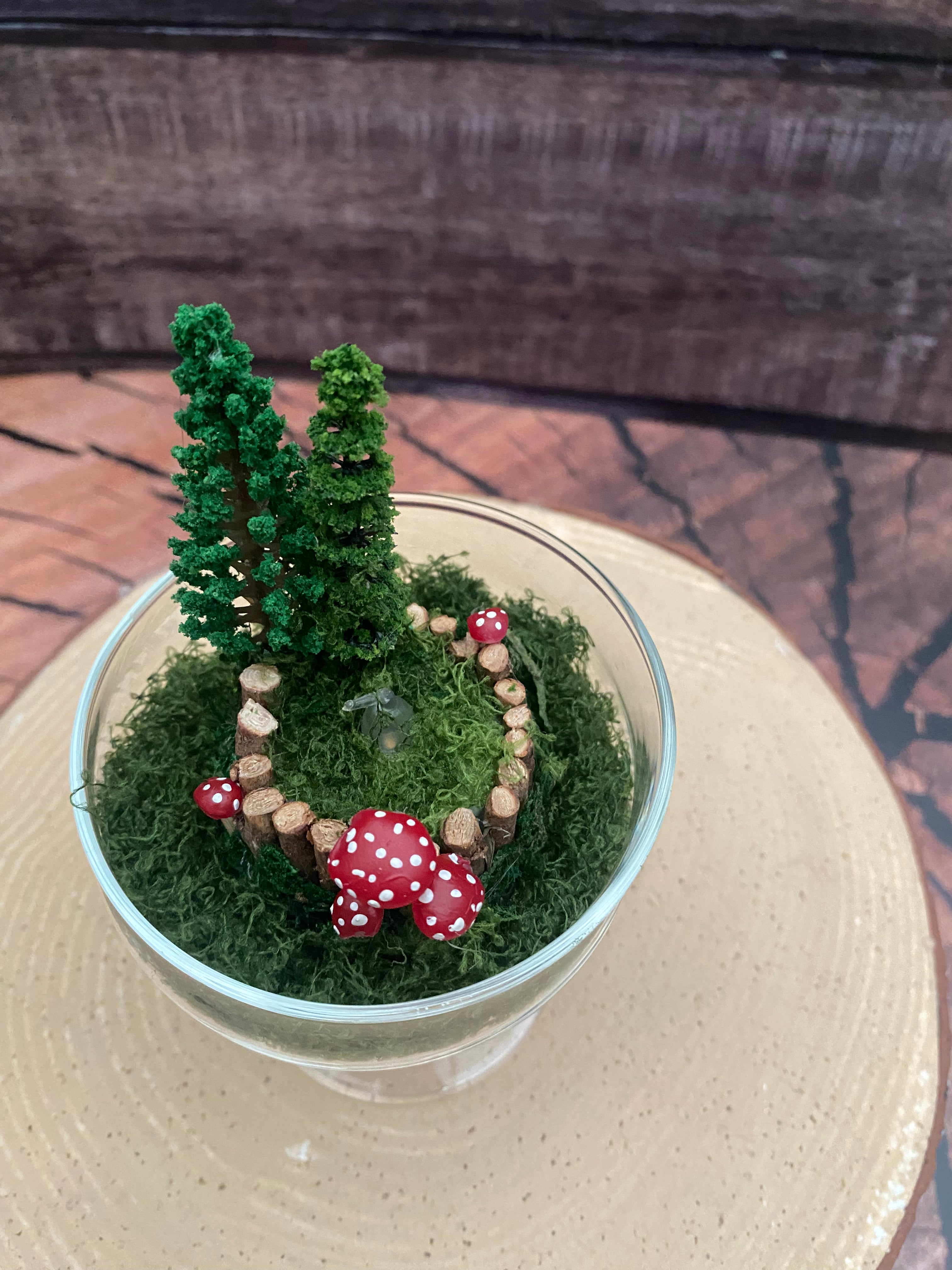 Flickering candle in mossy woodland scene