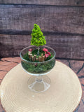 Flameless candle in mossy forest scene
