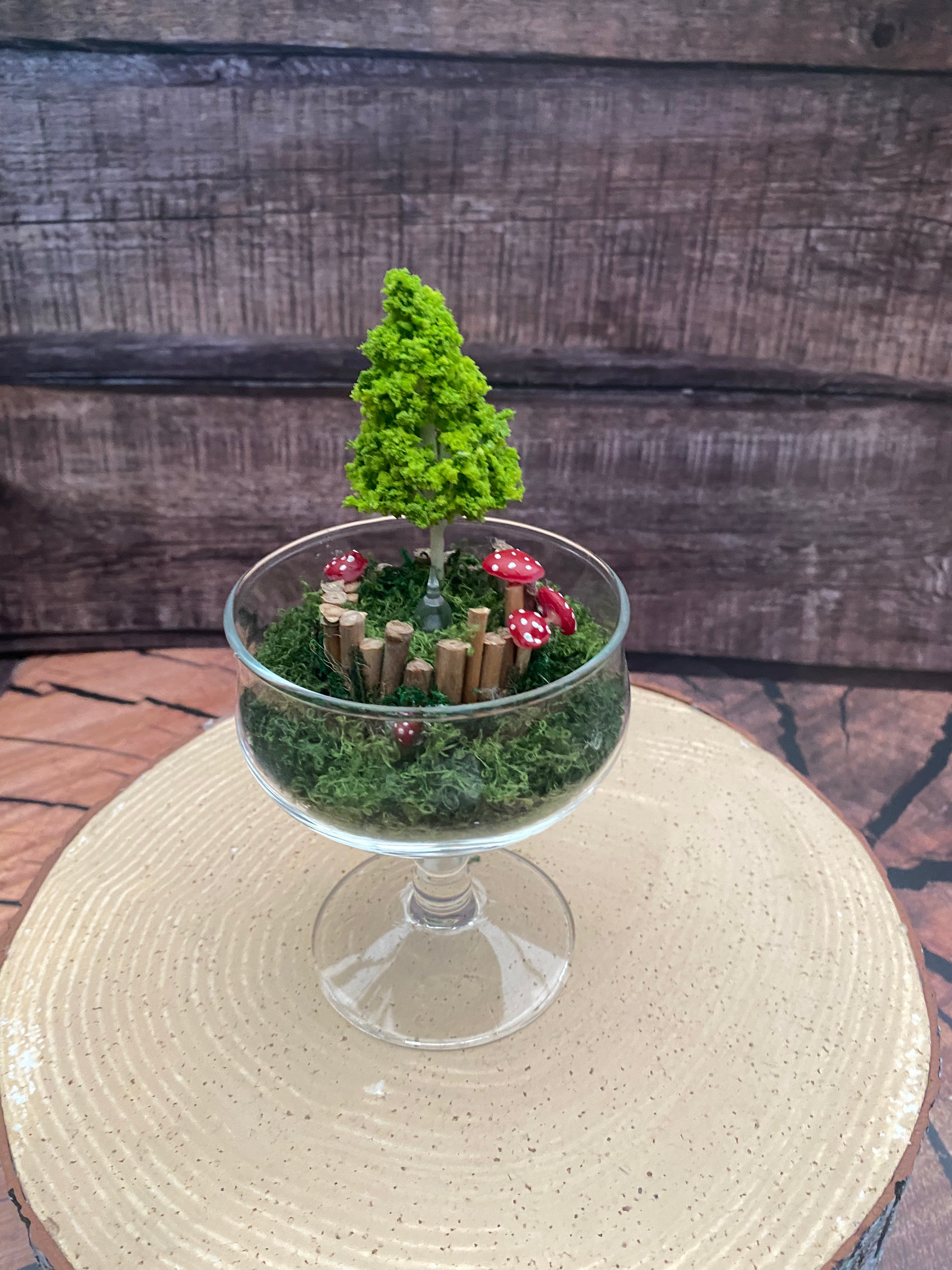 Flameless candle in mossy forest scene