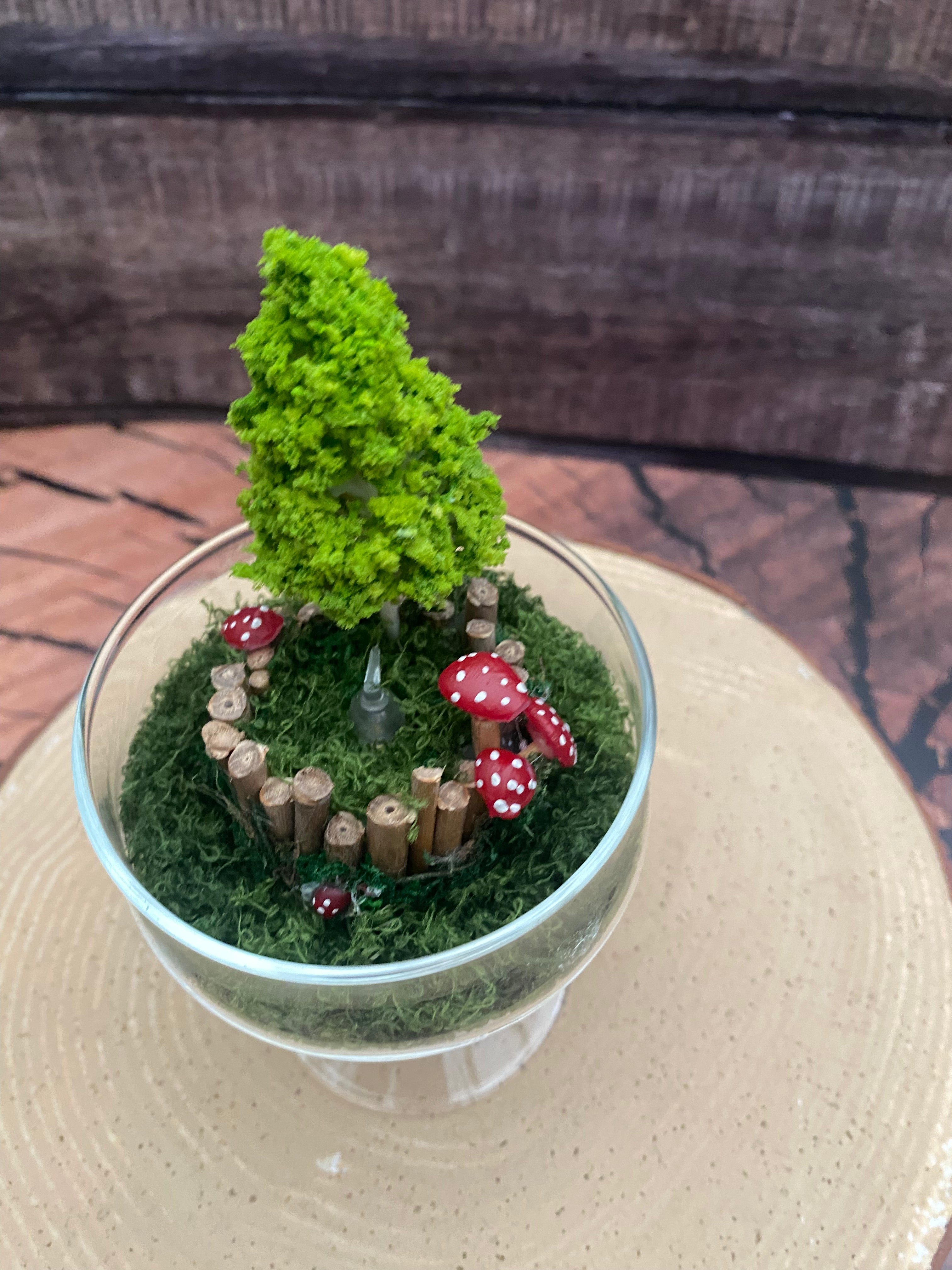 Flameless candle in mossy forest scene