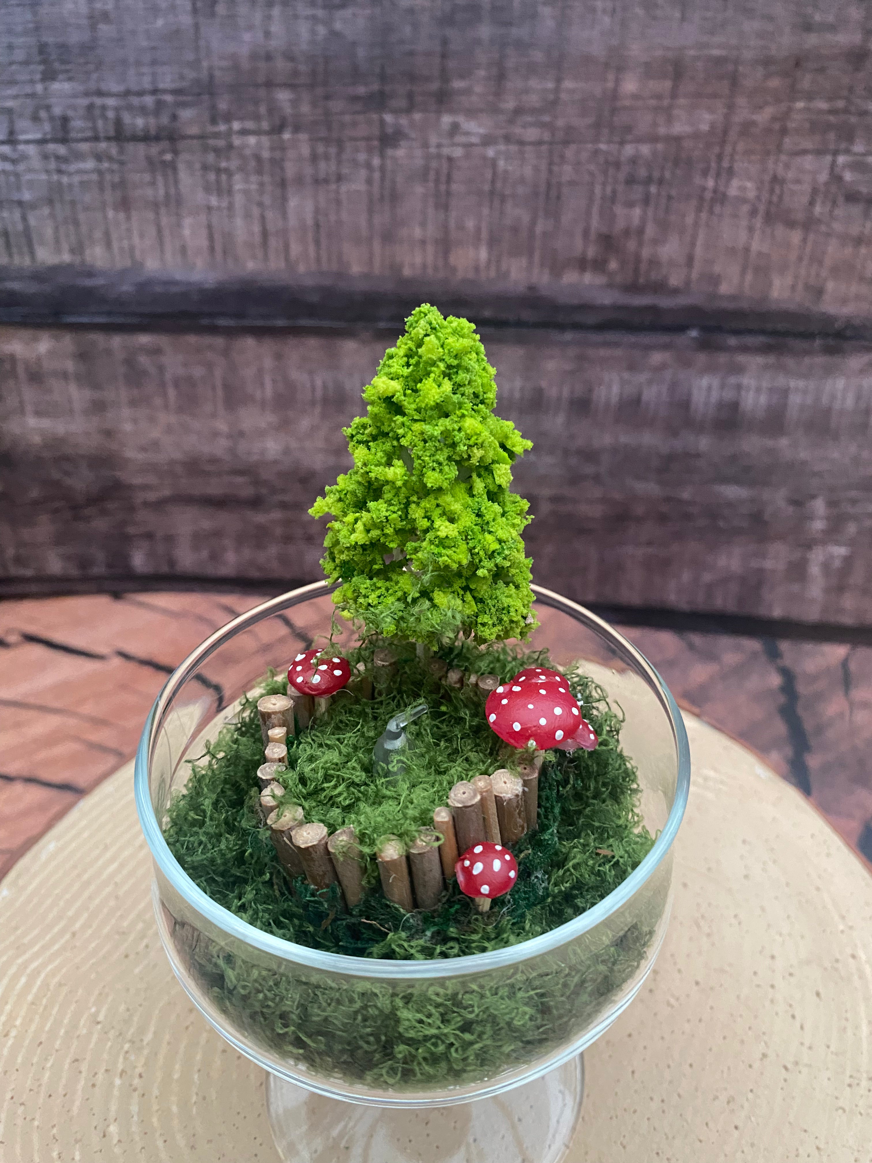 Flameless candle in mossy forest scene