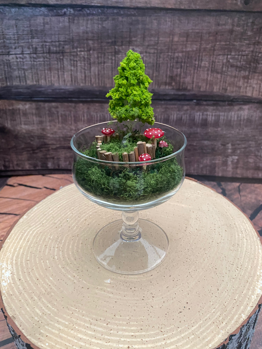 Flameless candle in mossy forest scene