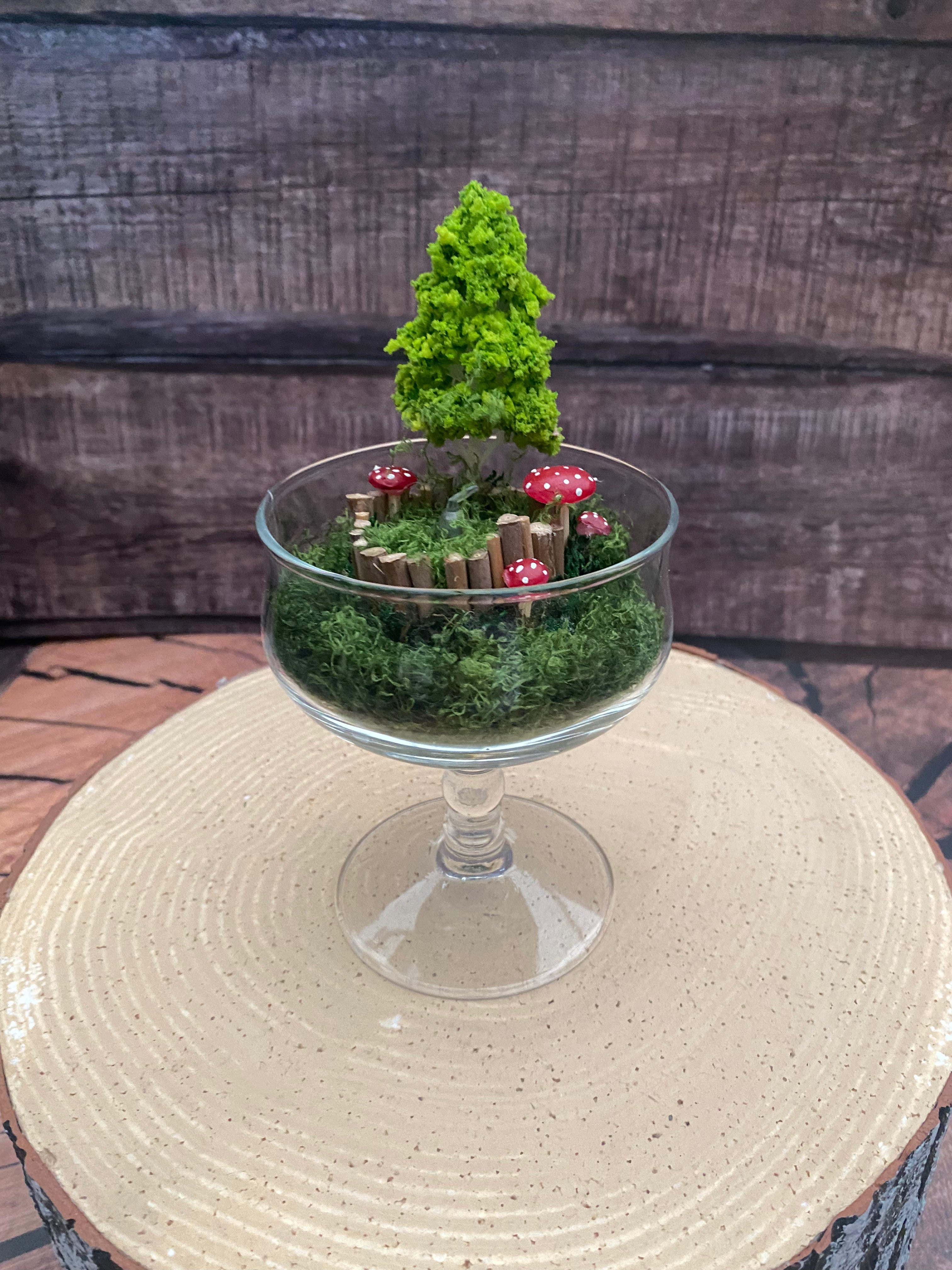 Flameless candle in mossy forest scene