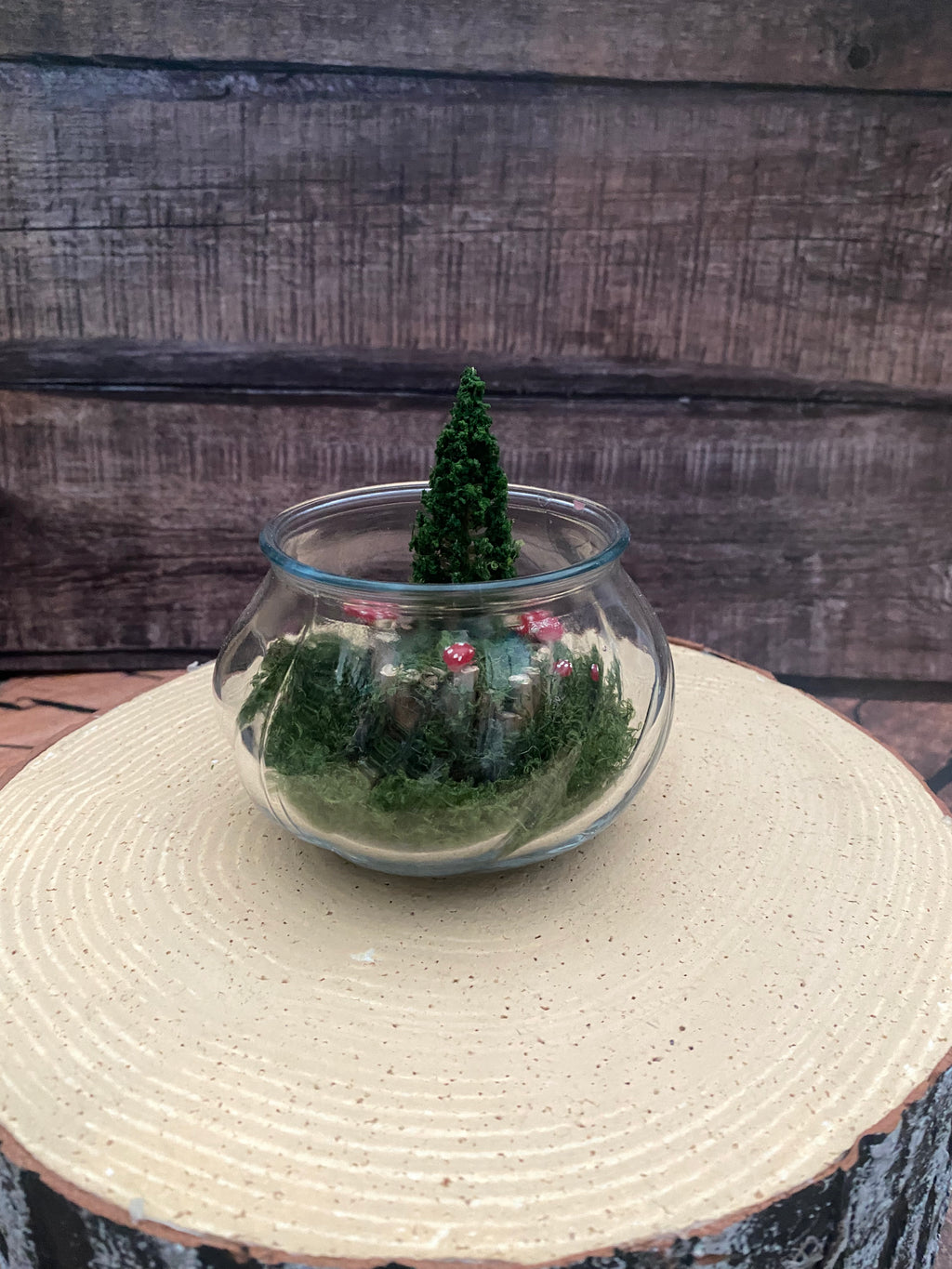 Flamless candle in mossy woodland scene in bevelled glass dish
