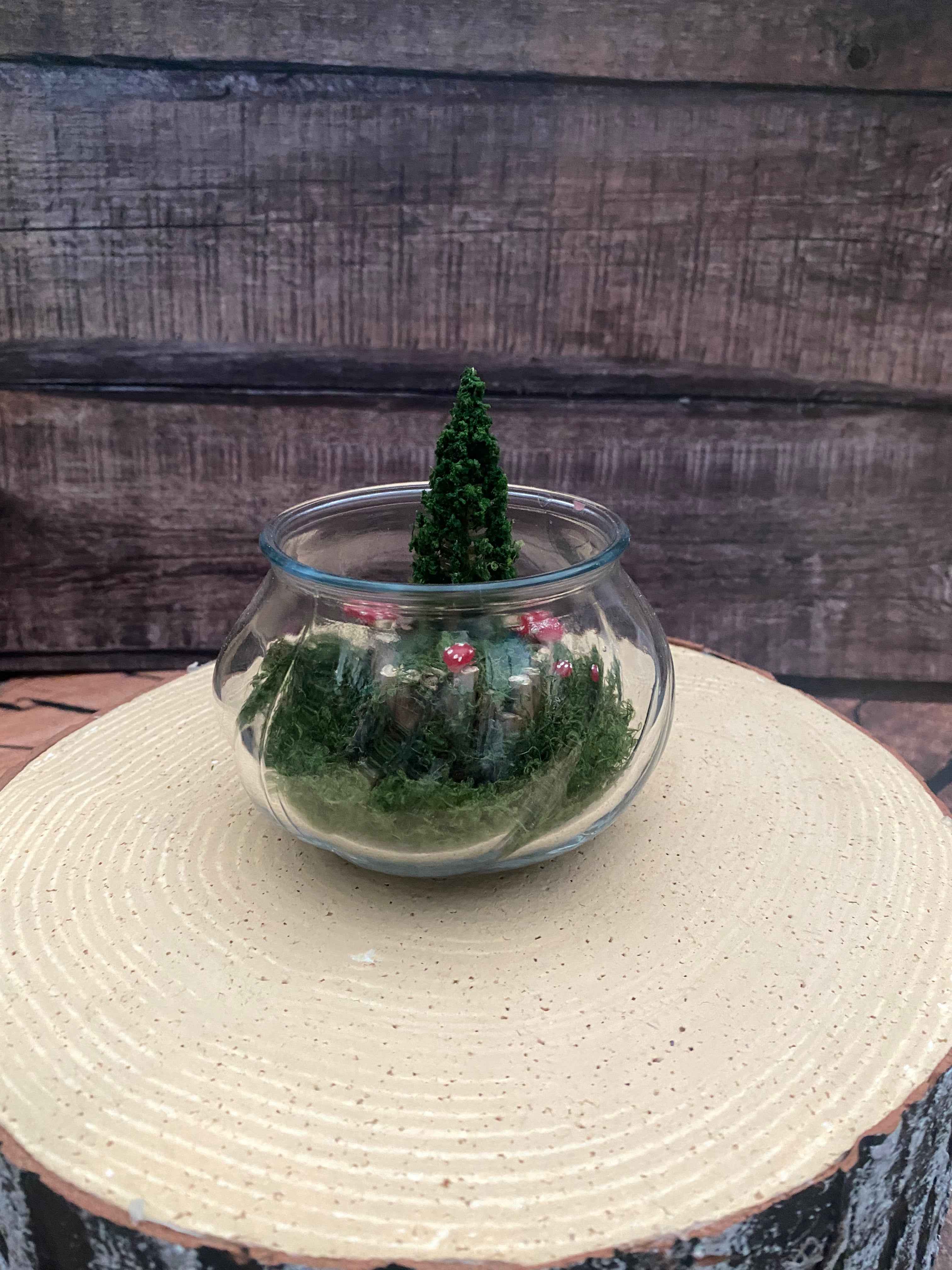 Flamless candle in mossy woodland scene in bevelled glass dish