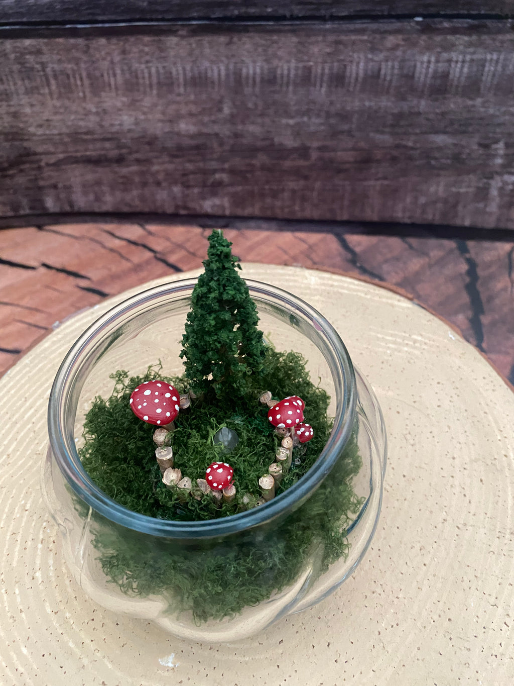 Flamless candle in mossy woodland scene in bevelled glass dish