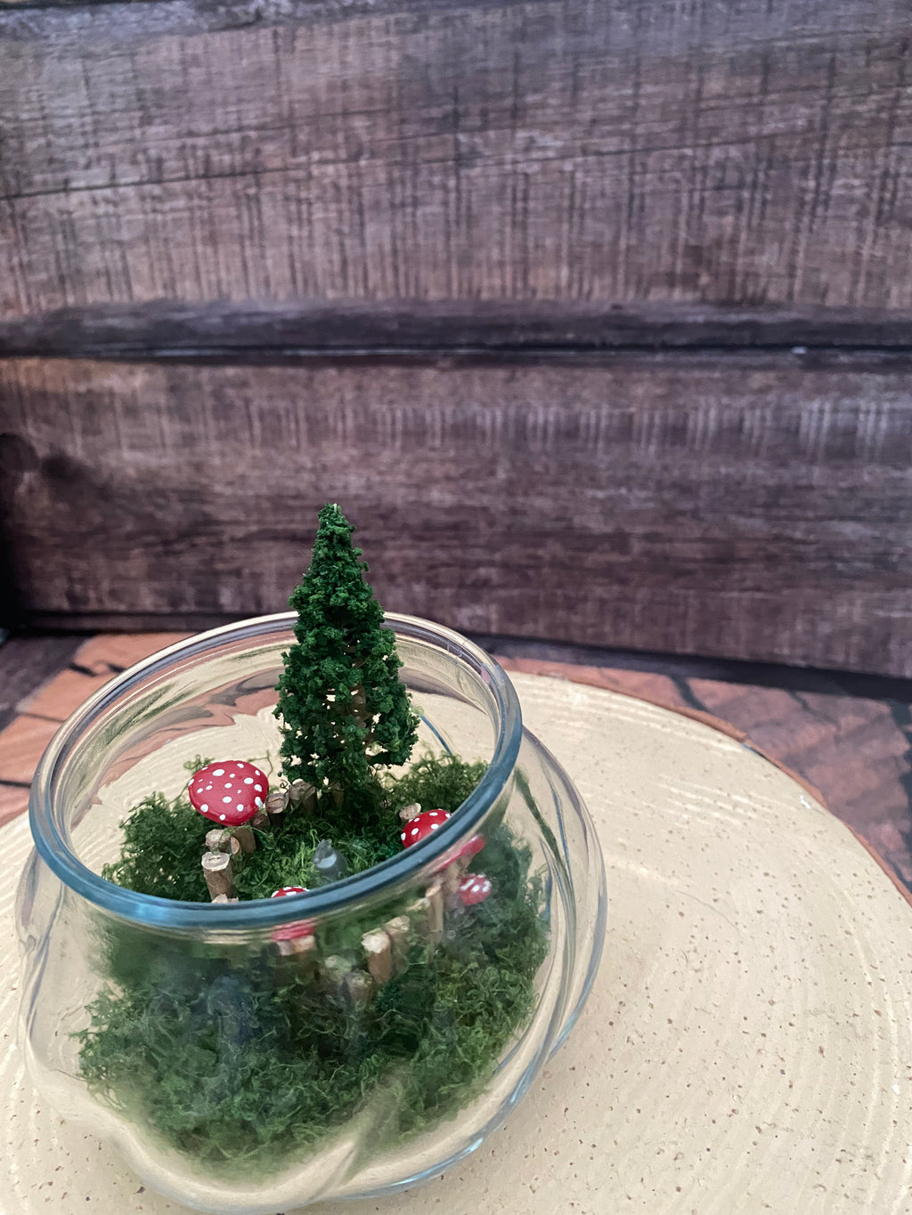 Flamless candle in mossy woodland scene in bevelled glass dish