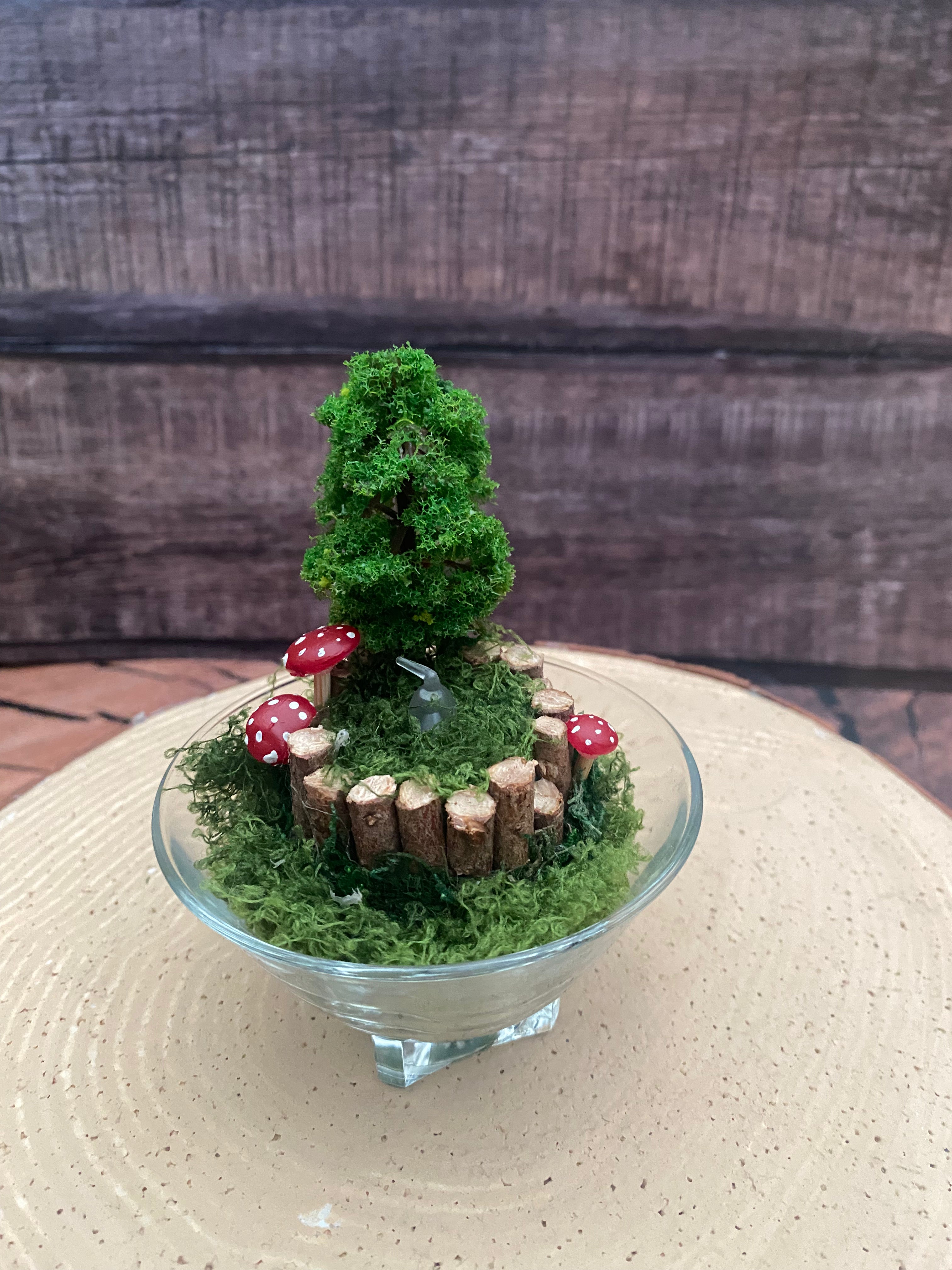 Flameless candle in smaller mossy forest scene