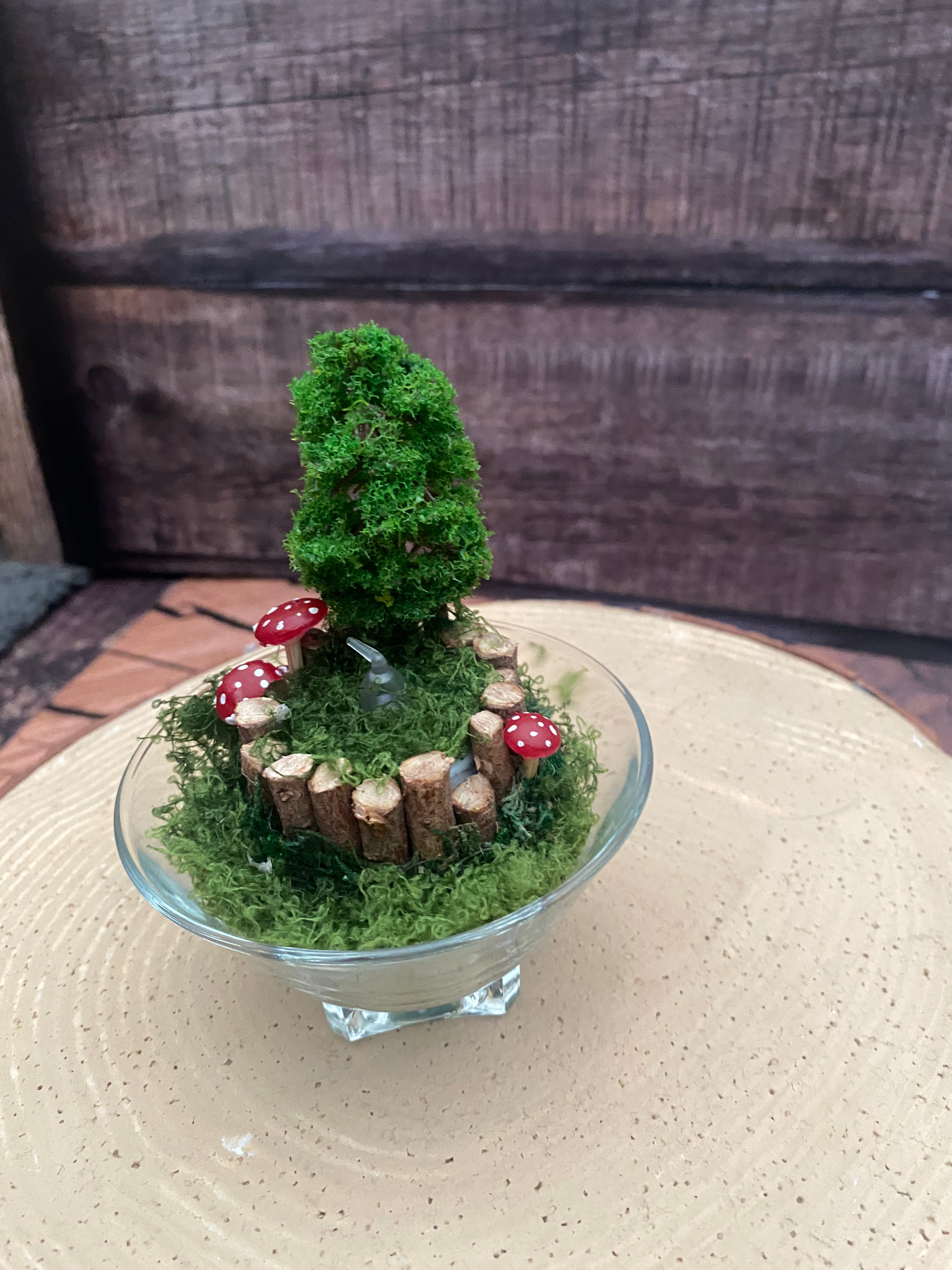 Flameless candle in smaller mossy forest scene