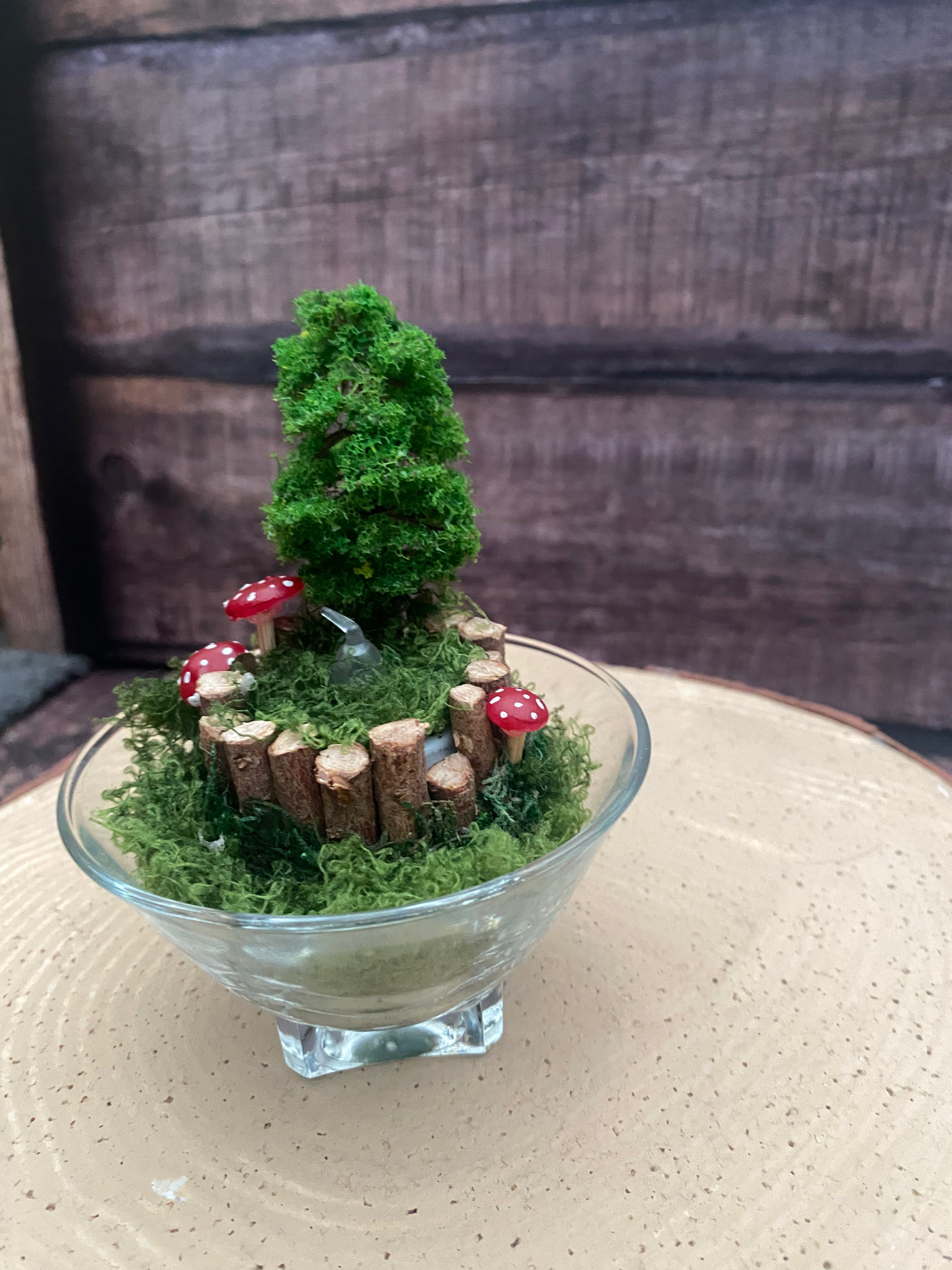 Flameless candle in smaller mossy forest scene