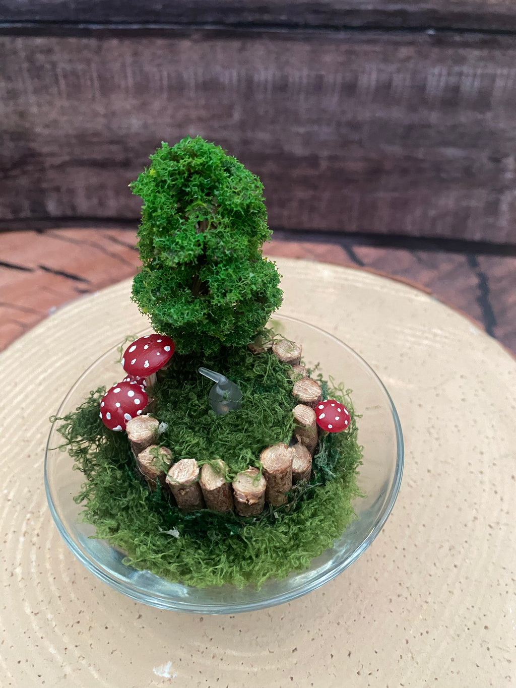 Flameless candle in smaller mossy forest scene