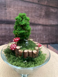 Flameless candle in smaller mossy forest scene