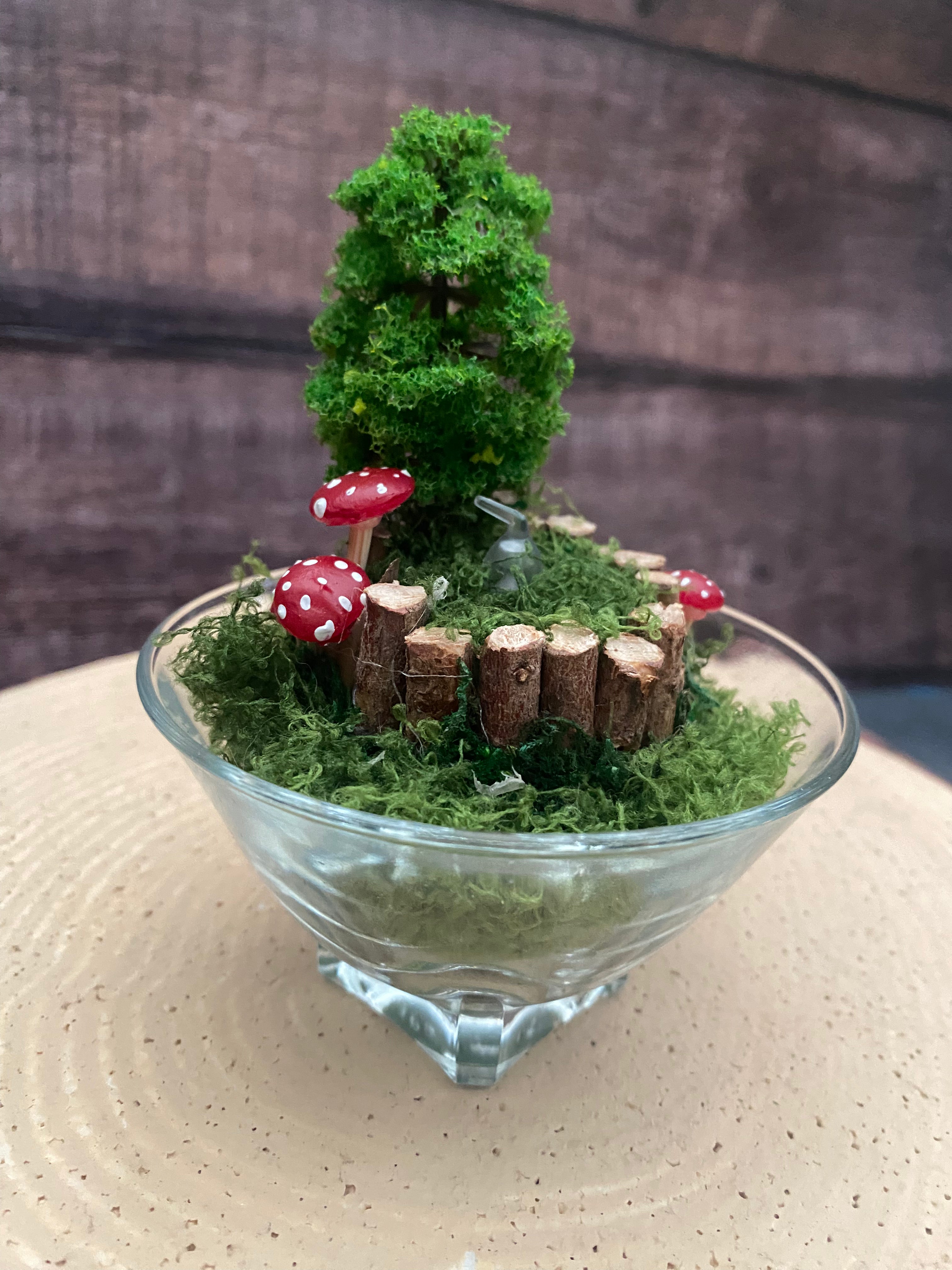 Flameless candle in smaller mossy forest scene