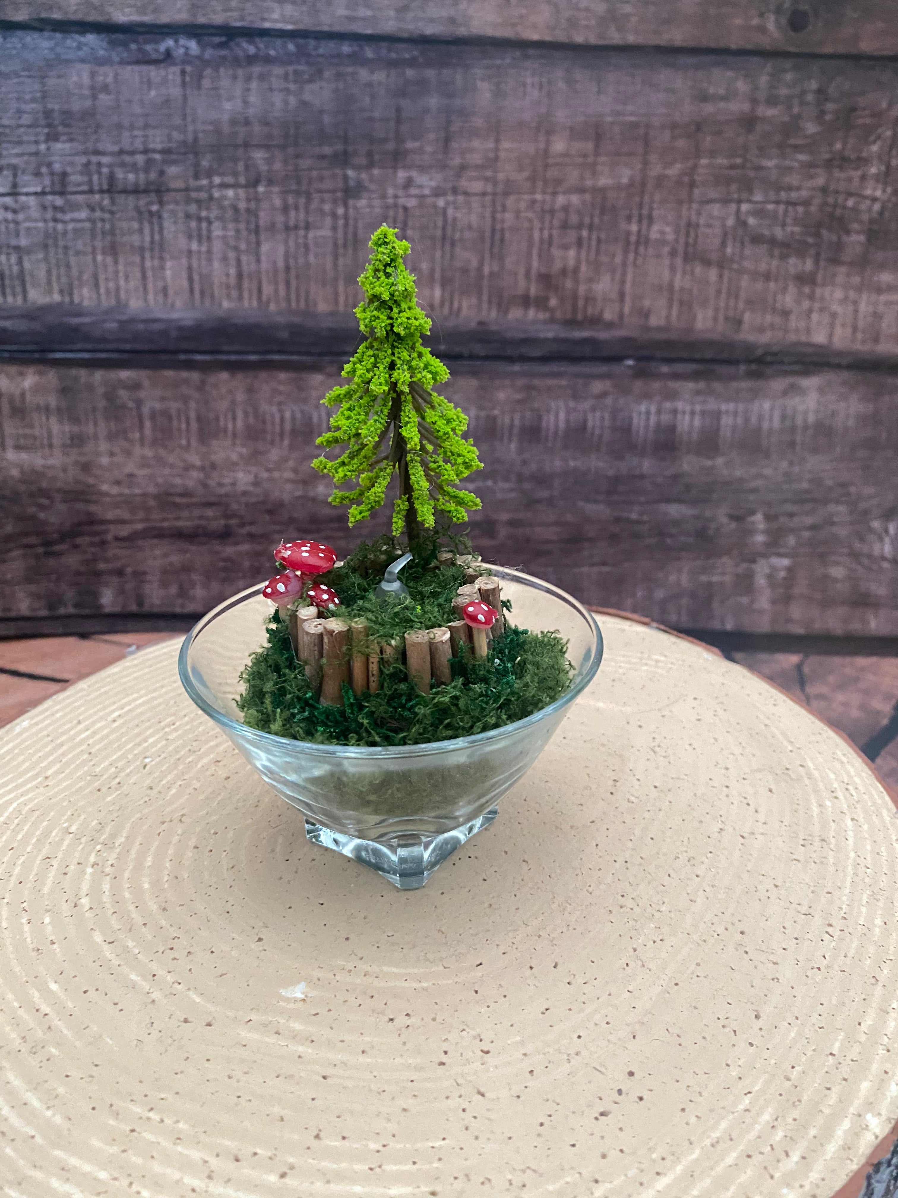 Flameless candle in smaller mossy woodland scene