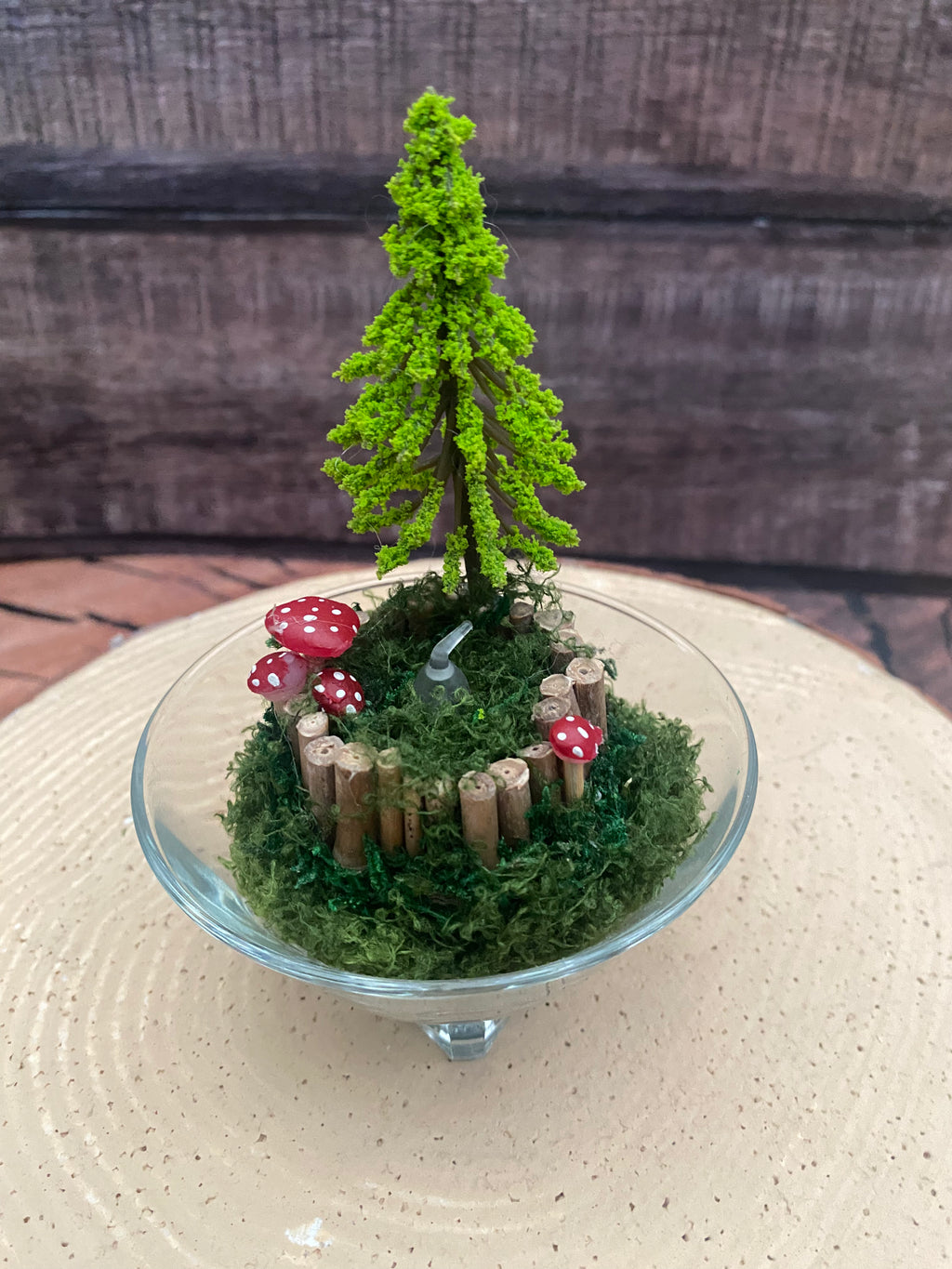 Flameless candle in smaller mossy woodland scene