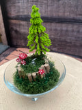 Flameless candle in smaller mossy woodland scene