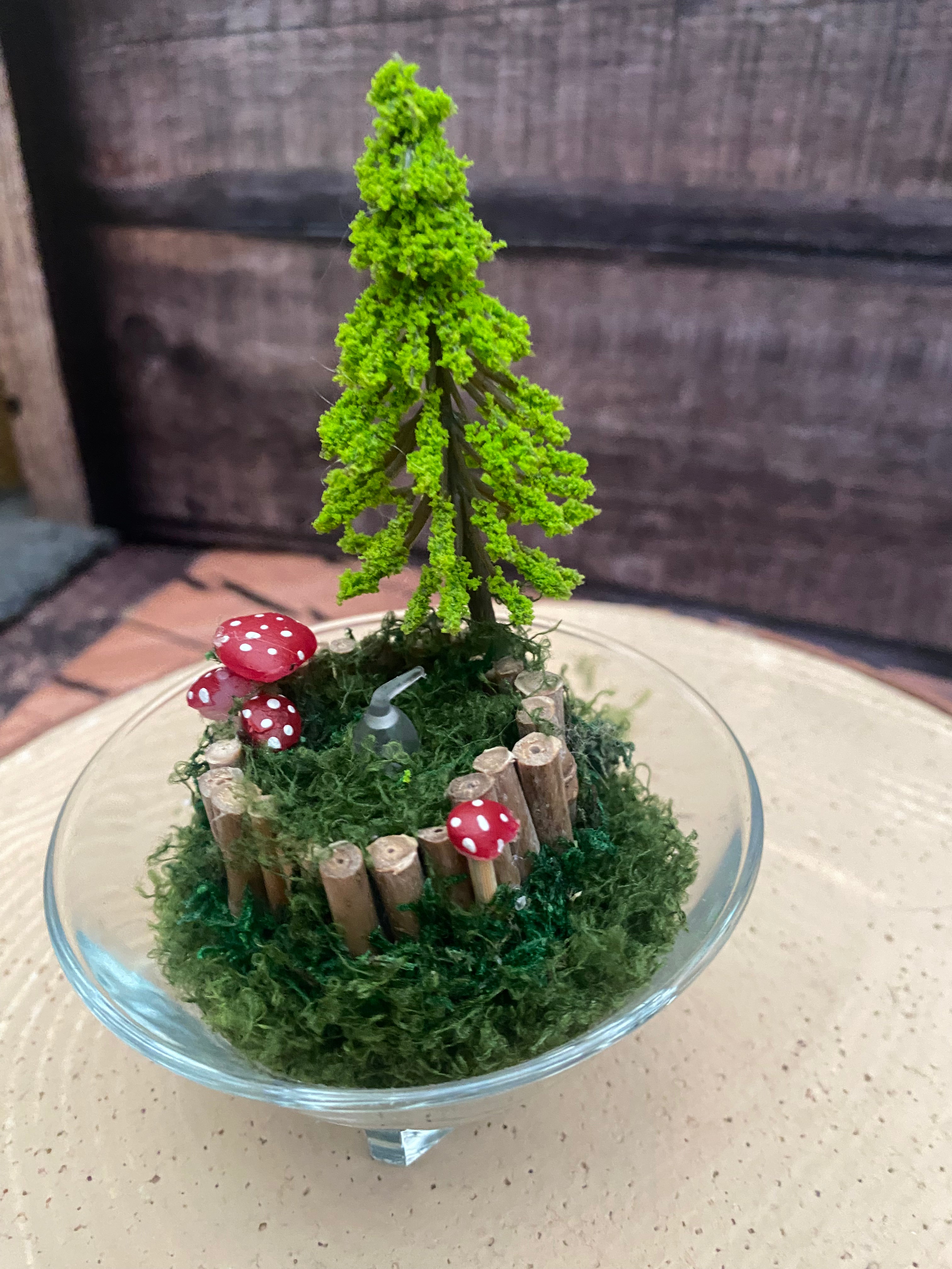 Flameless candle in smaller mossy woodland scene