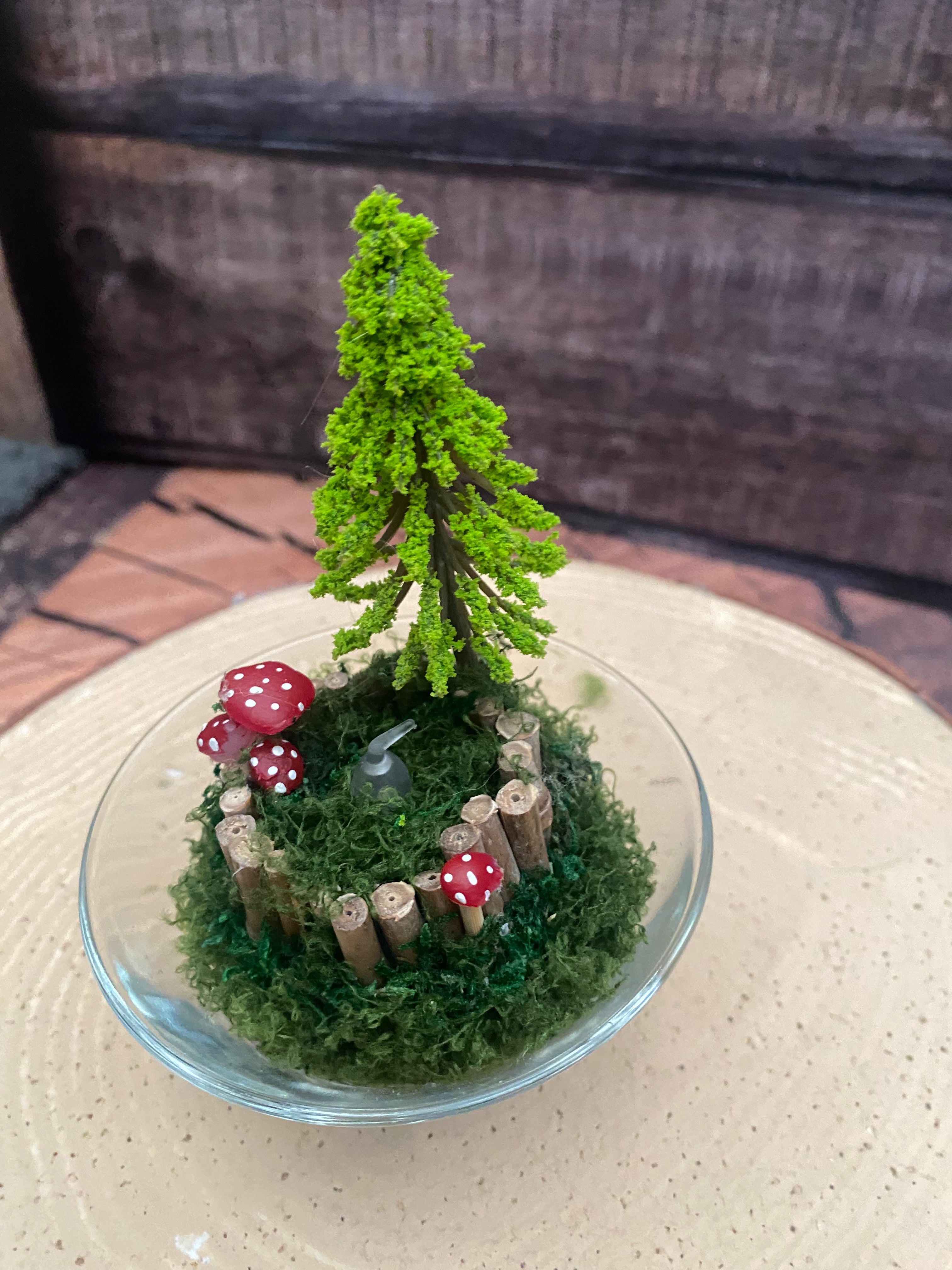 Flameless candle in smaller mossy woodland scene