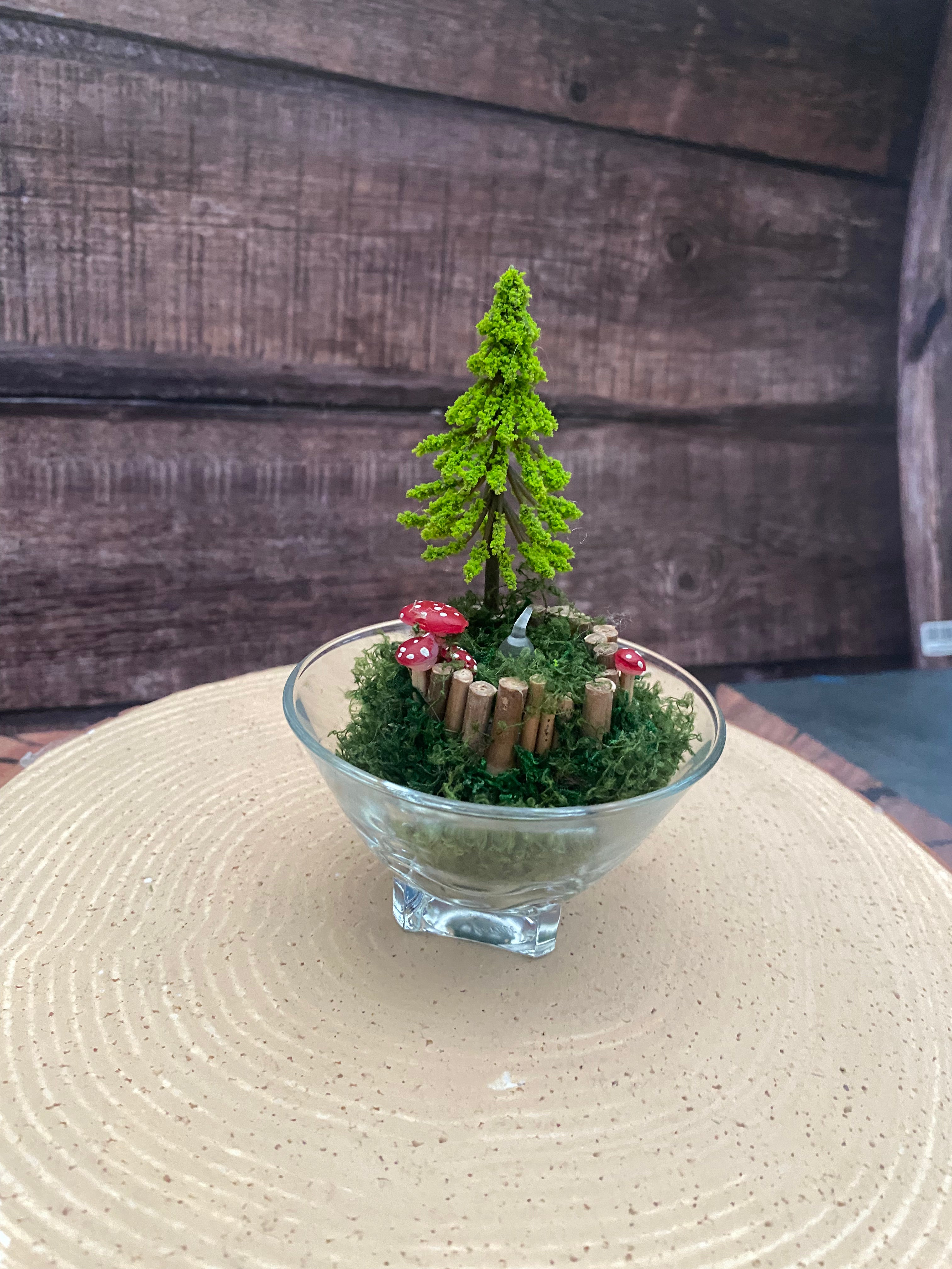 Flameless candle in smaller mossy woodland scene