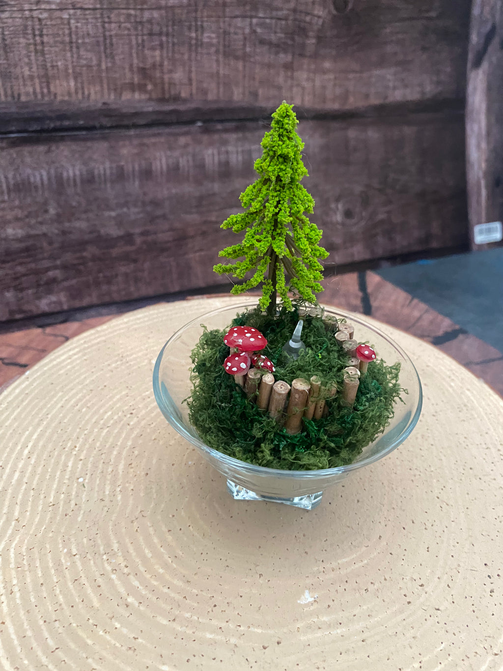 Flameless candle in smaller mossy woodland scene