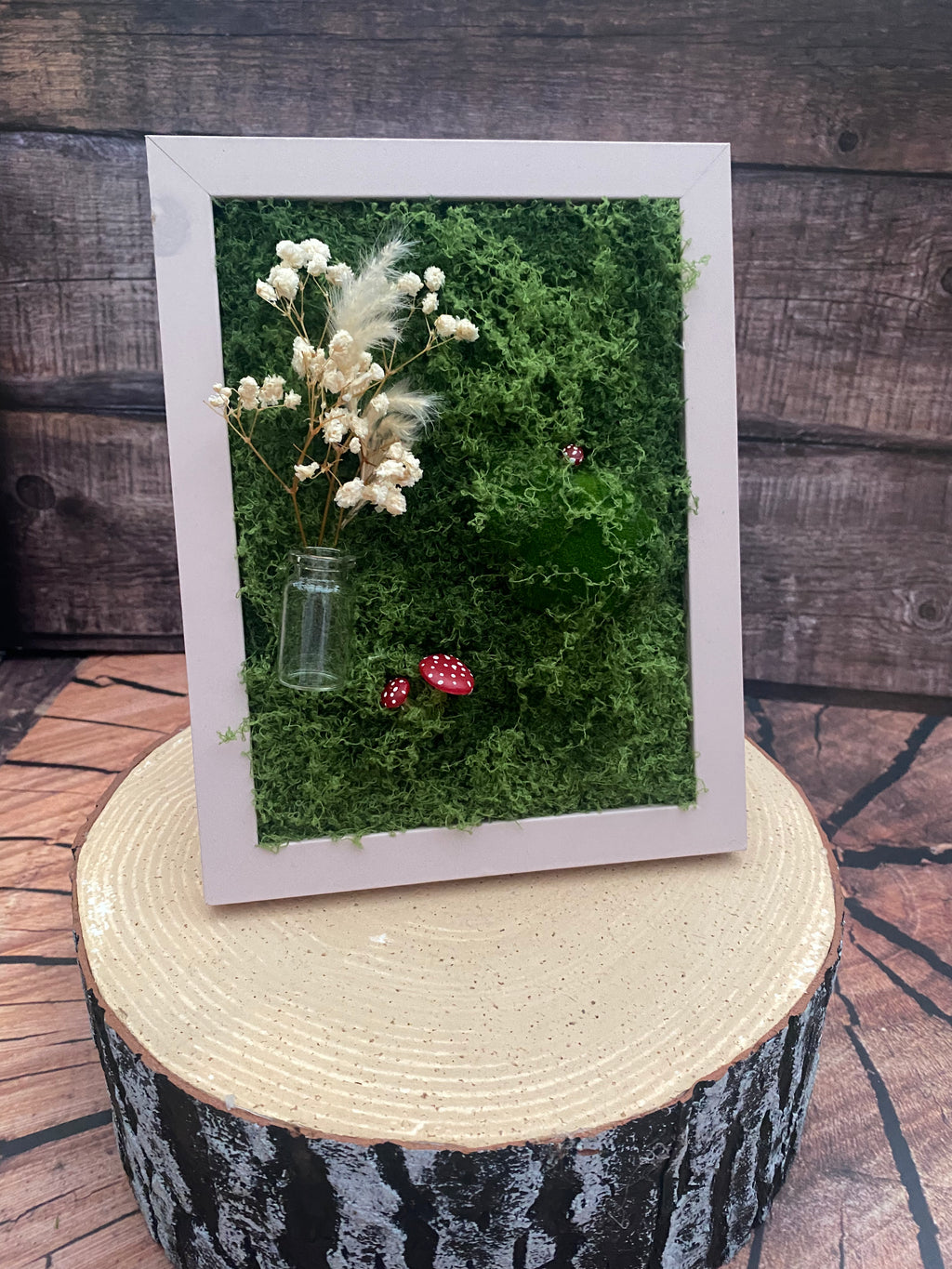 3D mossy scene with pink frame