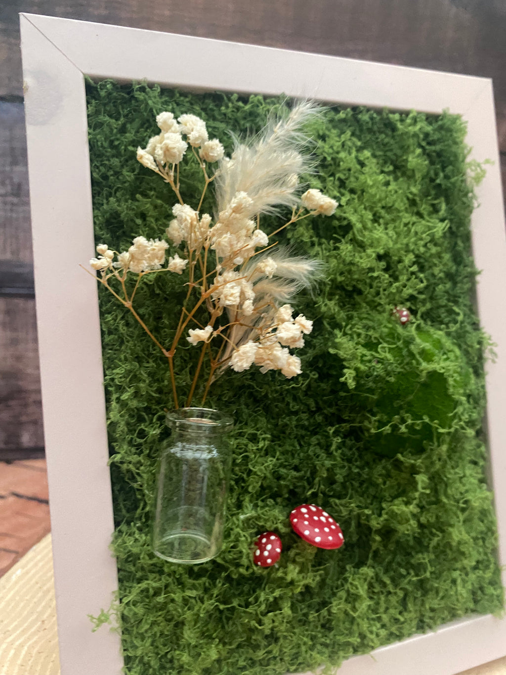 3D mossy scene with pink frame