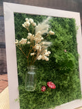 3D mossy scene with pink frame