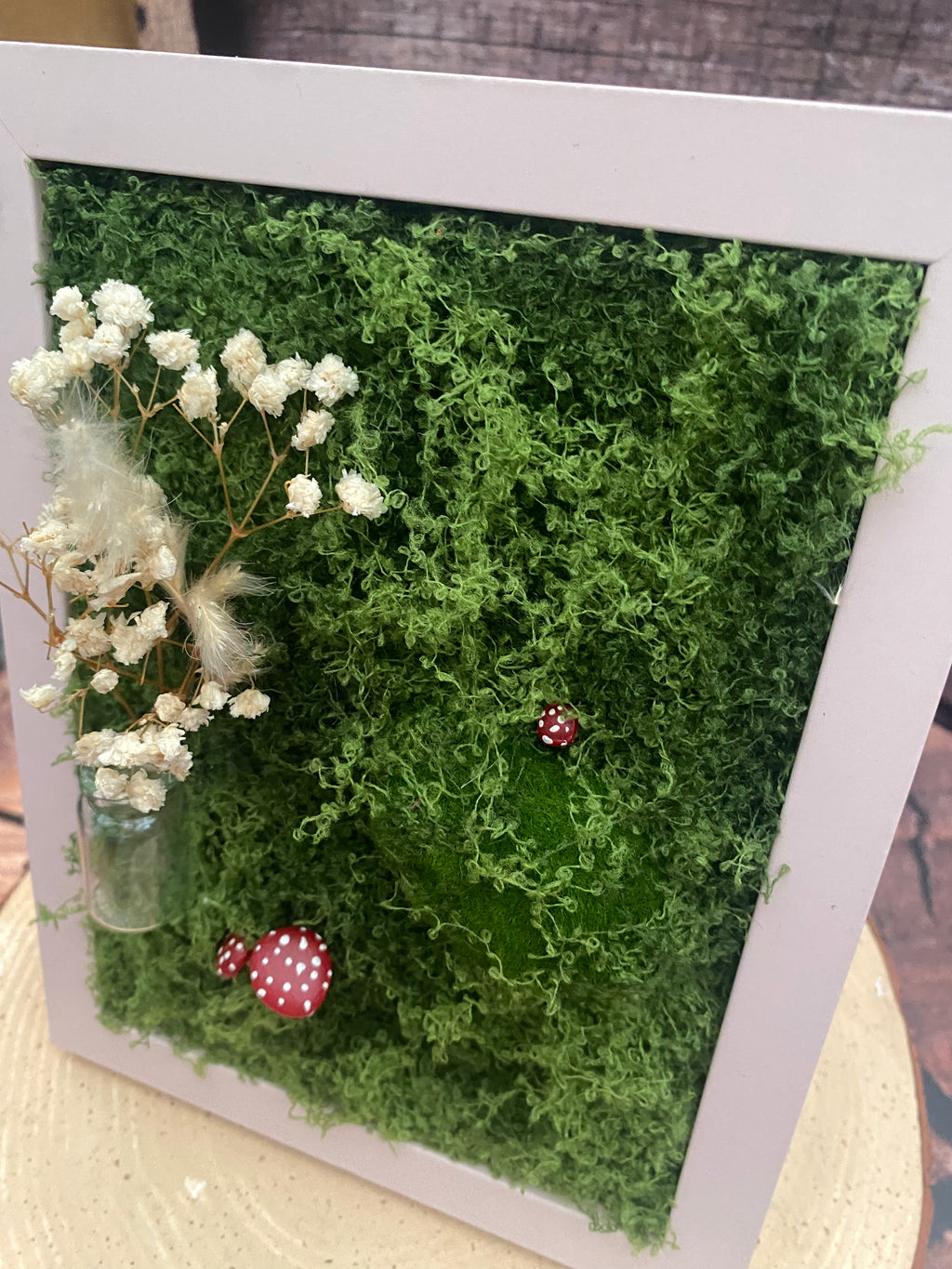 3D mossy scene with pink frame
