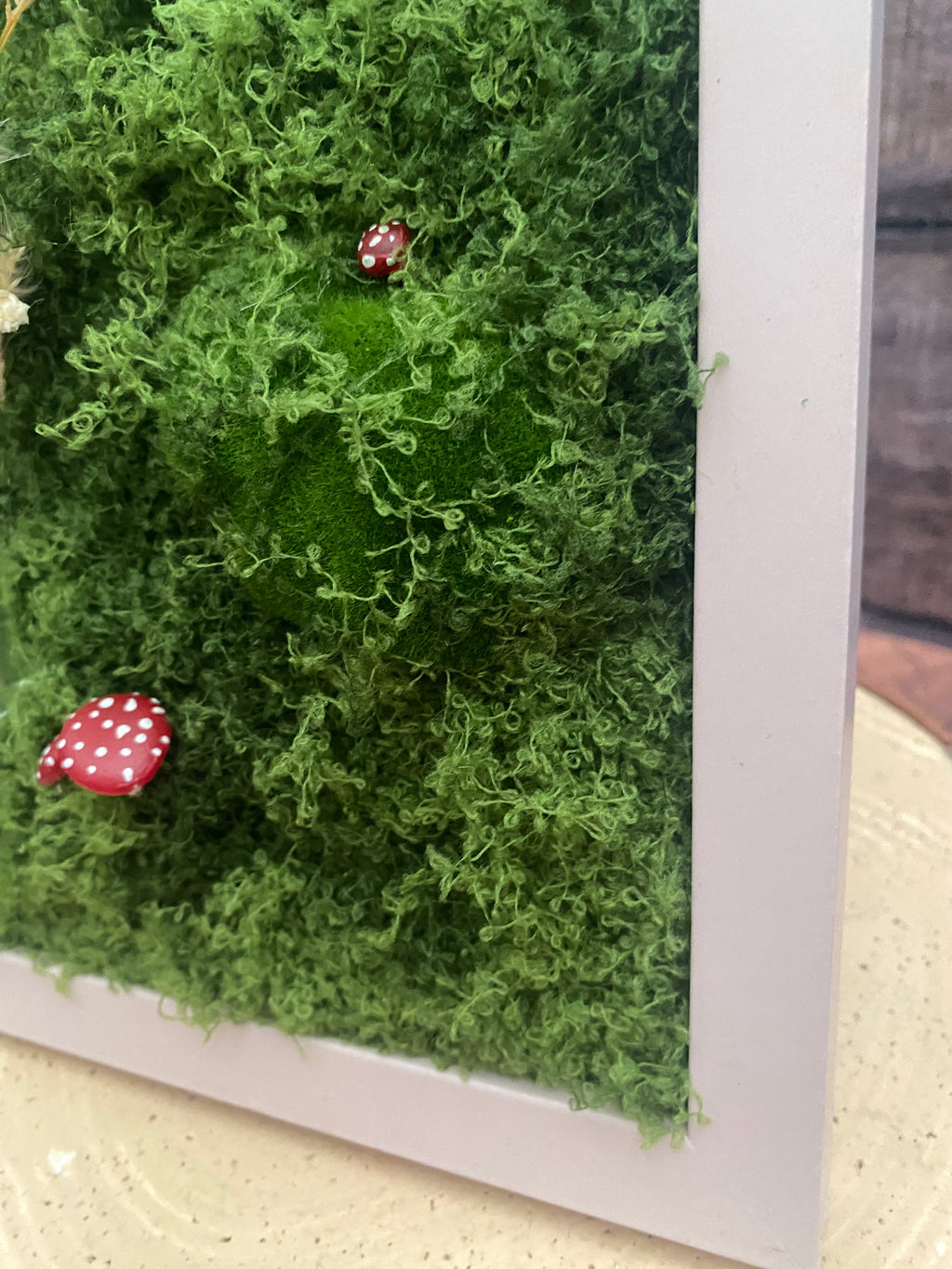 3D mossy scene with pink frame