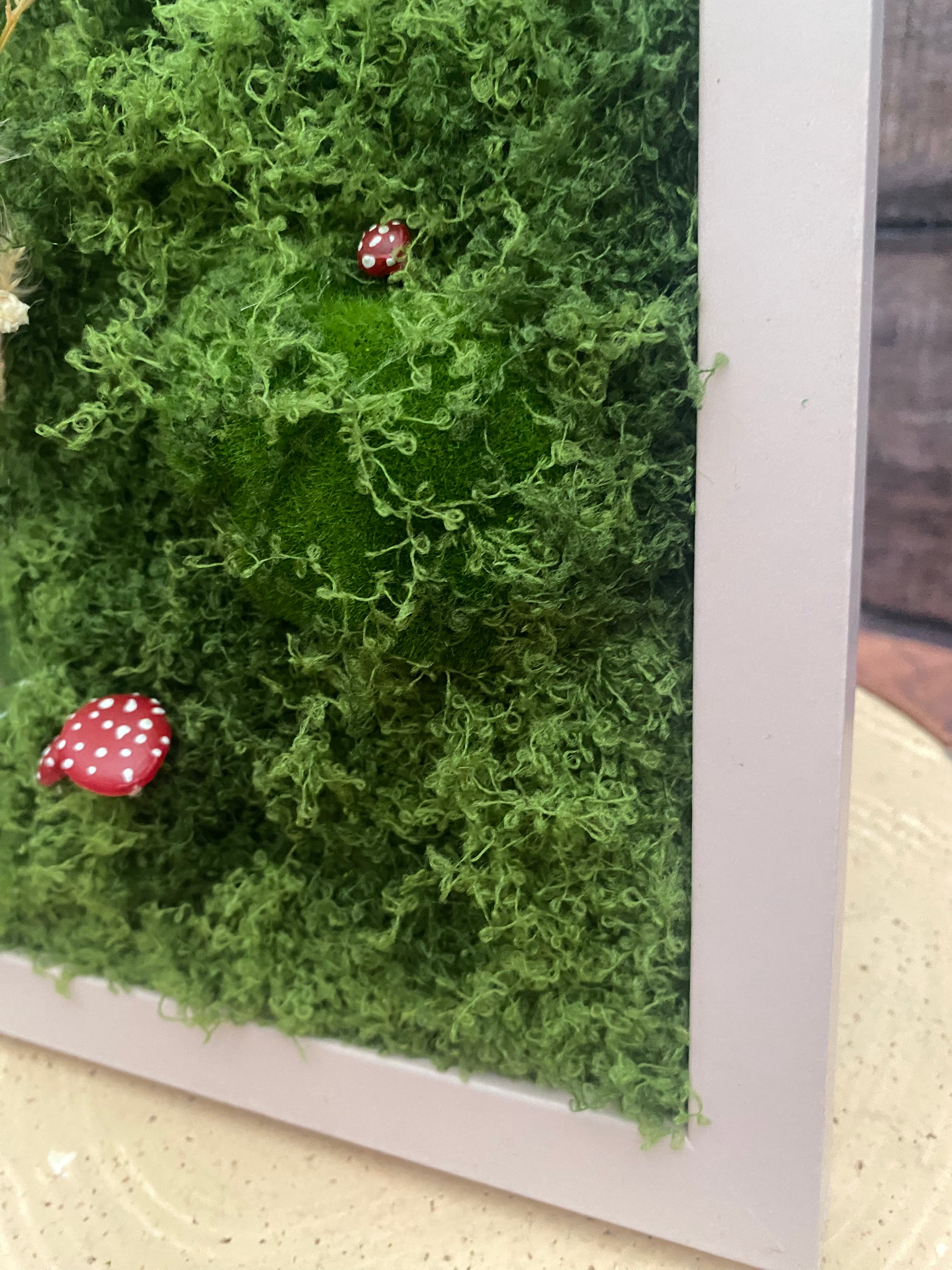 3D mossy scene with pink frame
