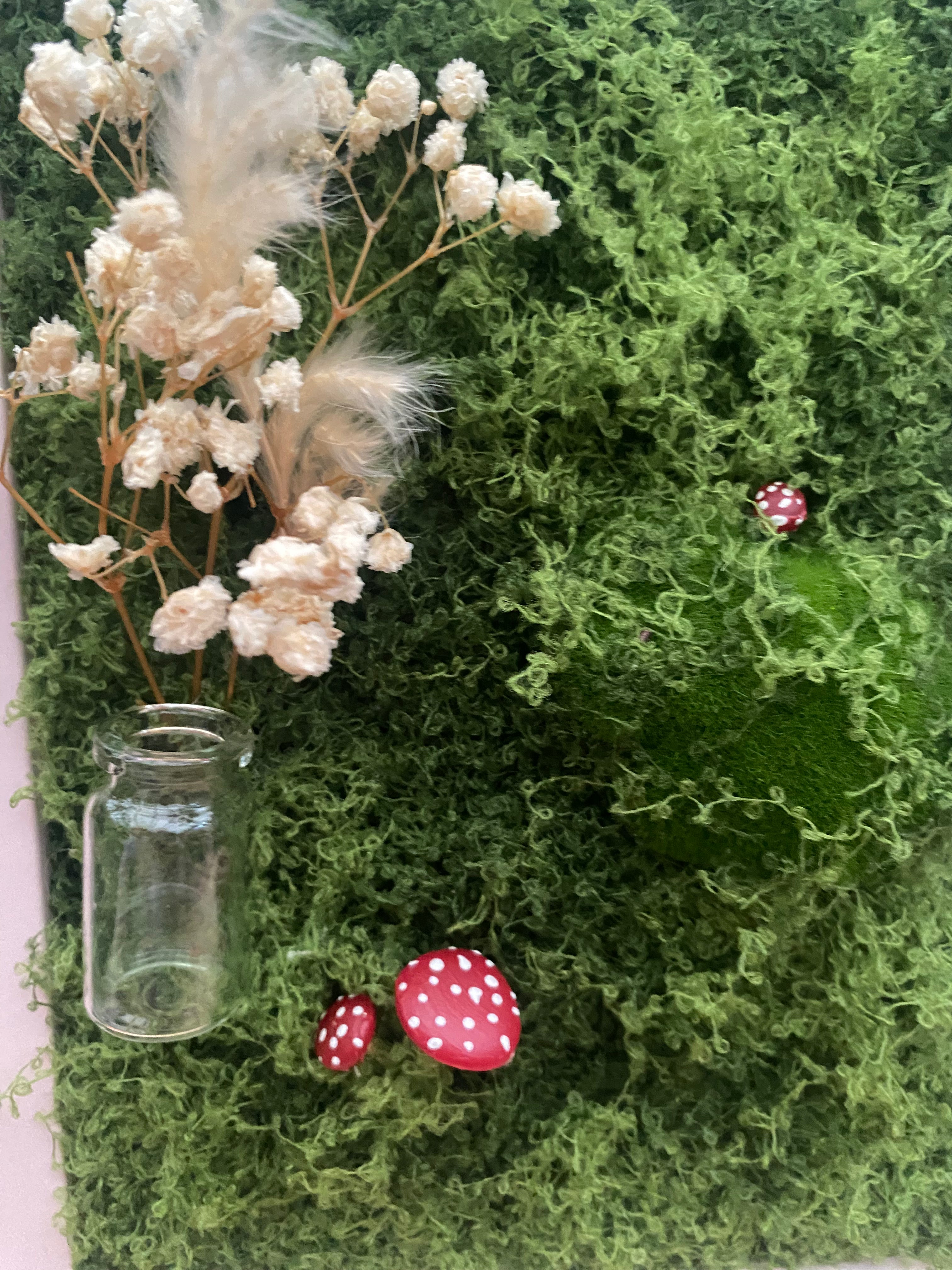 3D mossy scene with pink frame