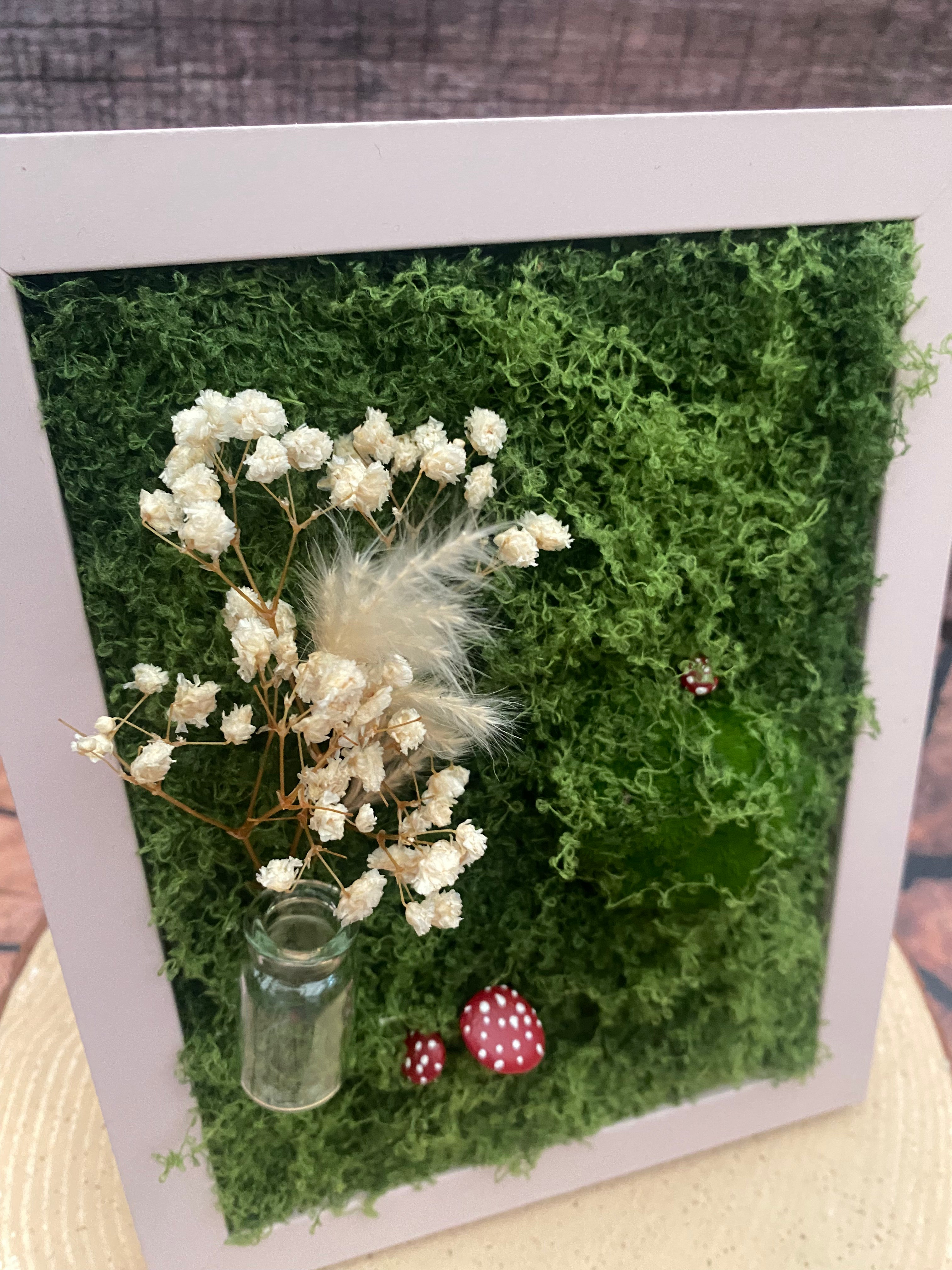 3D mossy scene with pink frame