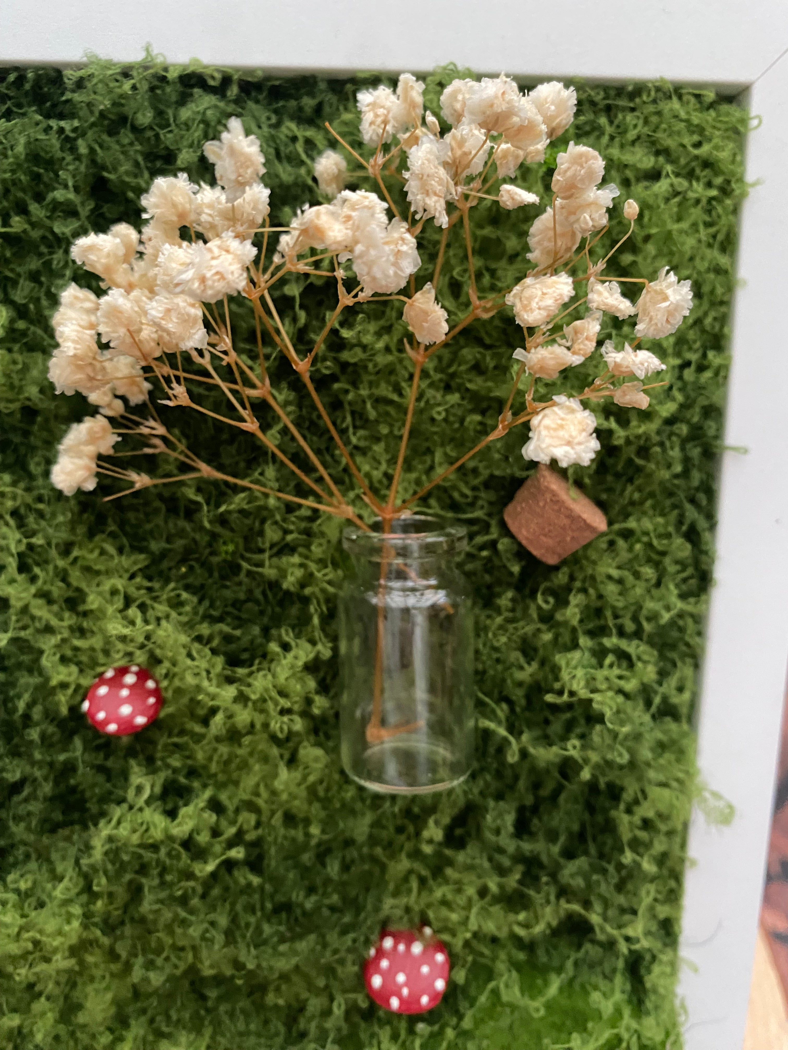 3D mossy scene with white frame
