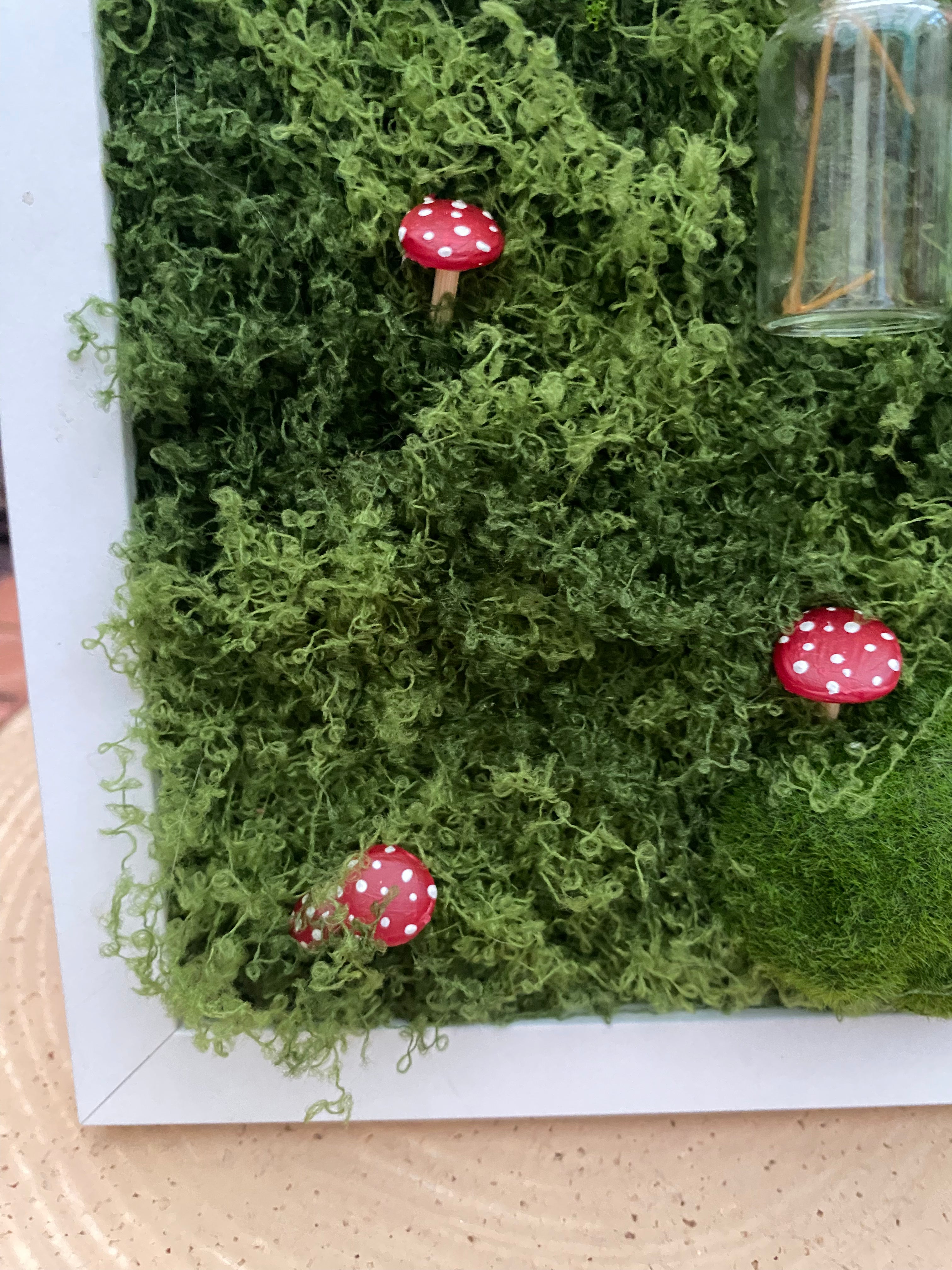 3D mossy scene with white frame