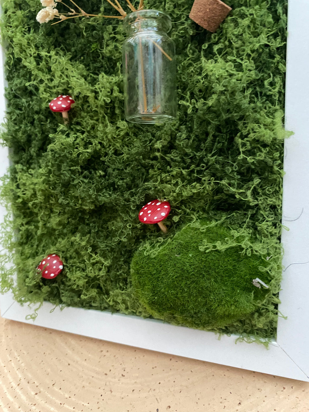 3D mossy scene with white frame