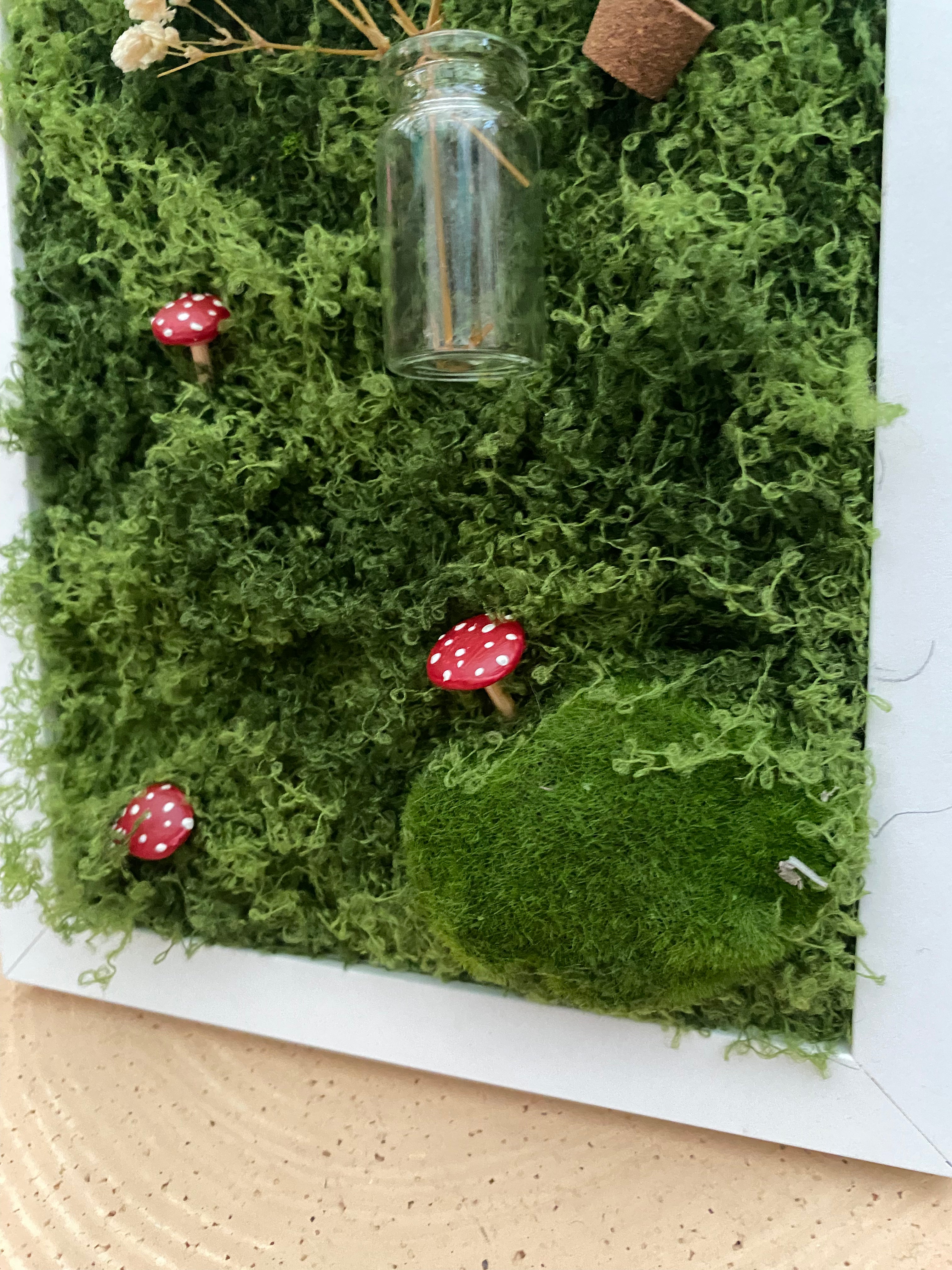 3D mossy scene with white frame