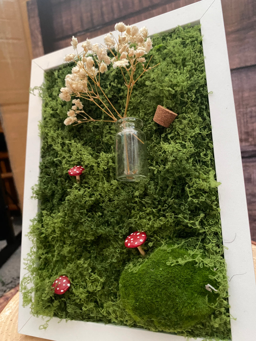 3D mossy scene with white frame